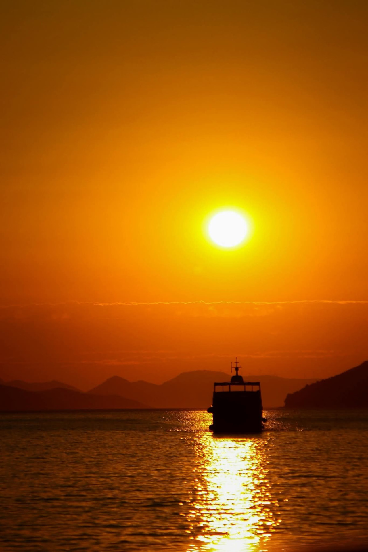 Sunset over the Adriatic Sea with a boat sailing